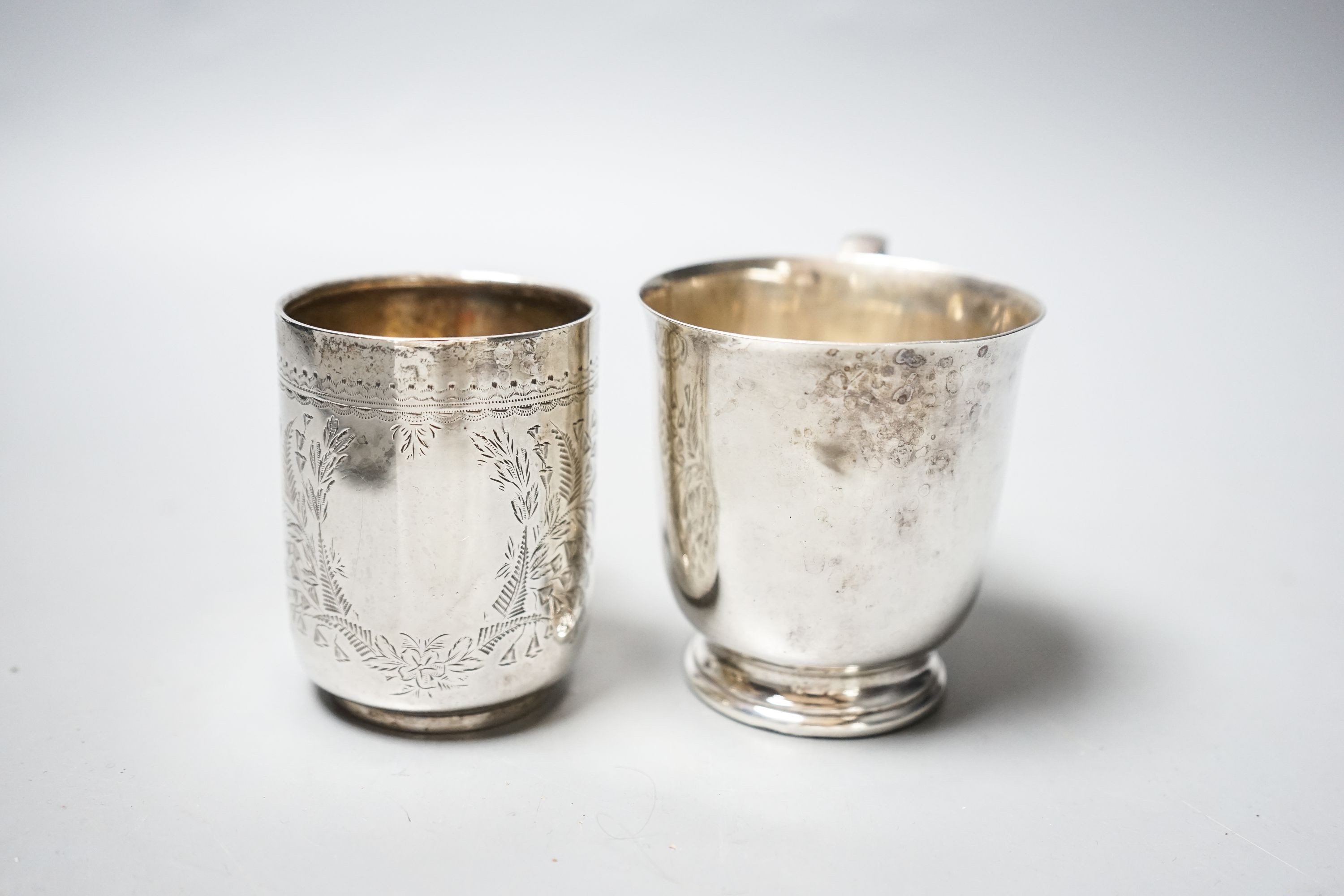 An Edwardian engraved silver christening mug, Chester, 1906, 73mm and a later silver mug, 6.5oz.